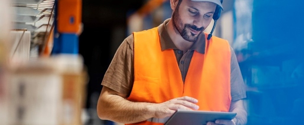 Warehouse supervisor reviewing an issue on his tablet