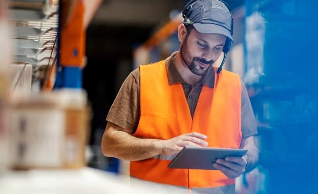 Warehouse supervisor reviewing an issue on his tablet