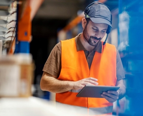 Warehouse supervisor reviewing an issue on his tablet