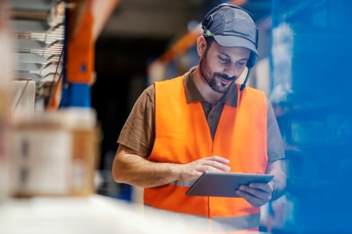 Warehouse supervisor reviewing an issue on his tablet