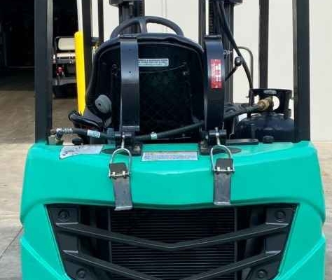 A green Mitsu forklift is displayed at Miami Industrial Trucks in Dayton, OH.